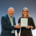 Alternativtext (Alt-Text): IHL-Rektor Prof. Dr. Volker Gäckle überreicht Frau Dr. Anna Fiona Weiß die Ernennungsurkunde zur Professorin an der Internationalen Hochschule Liebenzell. Beide stehen lächelnd nebeneinander und halten gemeinsam die gerahmte Urkunde in den Händen.
